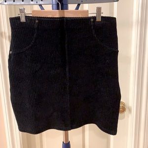 Black corduroy skirt. Fake pockets on the sides